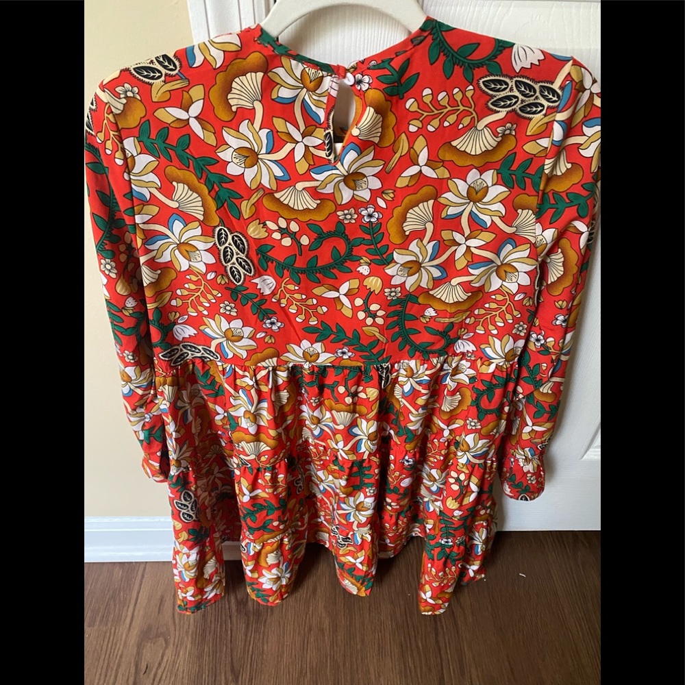 Long sleeve red floral peplum mini dress with ruffle detail on end of sleeves